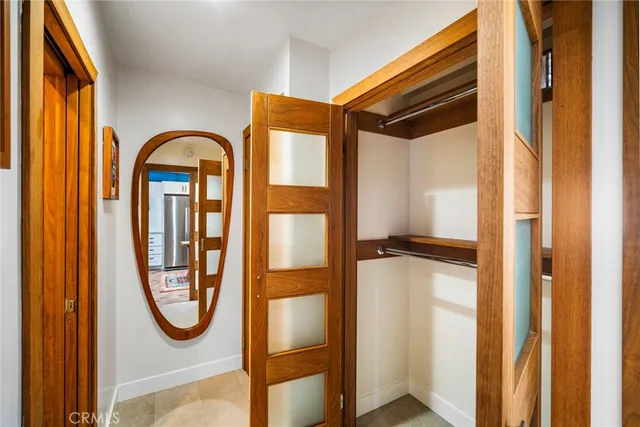 a view of walk in closet with a mirror