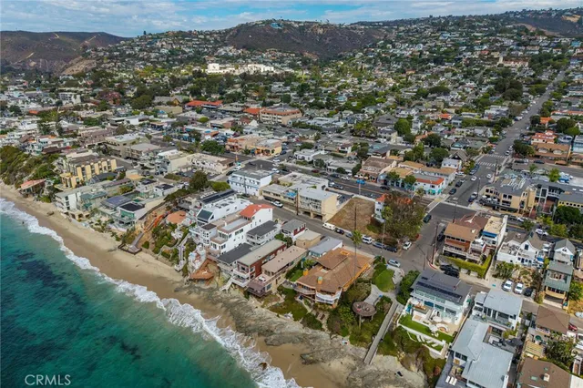 an aerial view of residential houses with city view