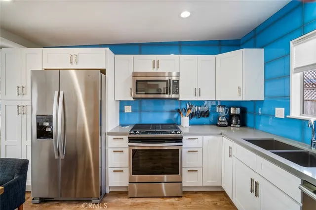 a kitchen with cabinets and steel stainless steel appliances