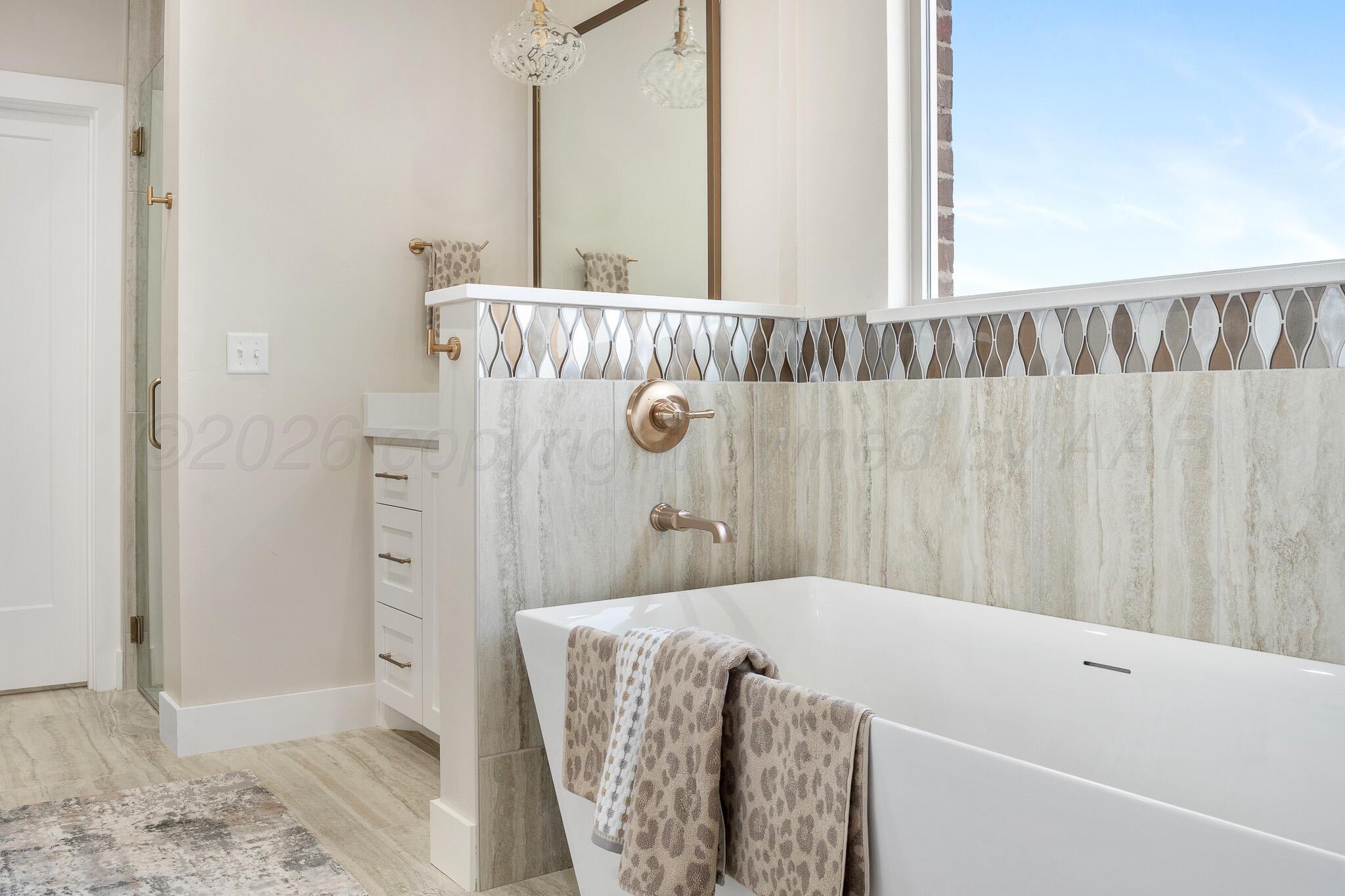 4000 Juniper Springs Road Amarillo, TX 79119 - Photo 24 of 40 a bathroom with a bathtub and shower