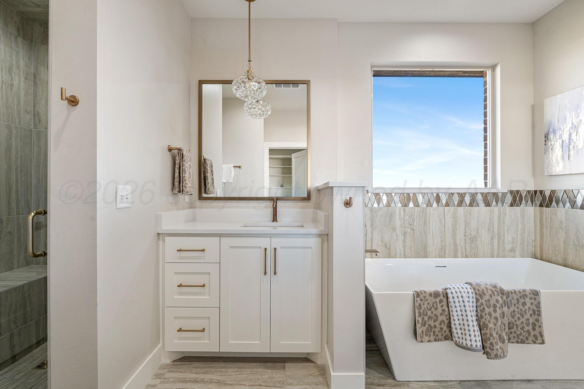 4000 Juniper Springs Road Amarillo, TX 79119 - Photo 25 of 40 a bathroom with a sink and a mirror