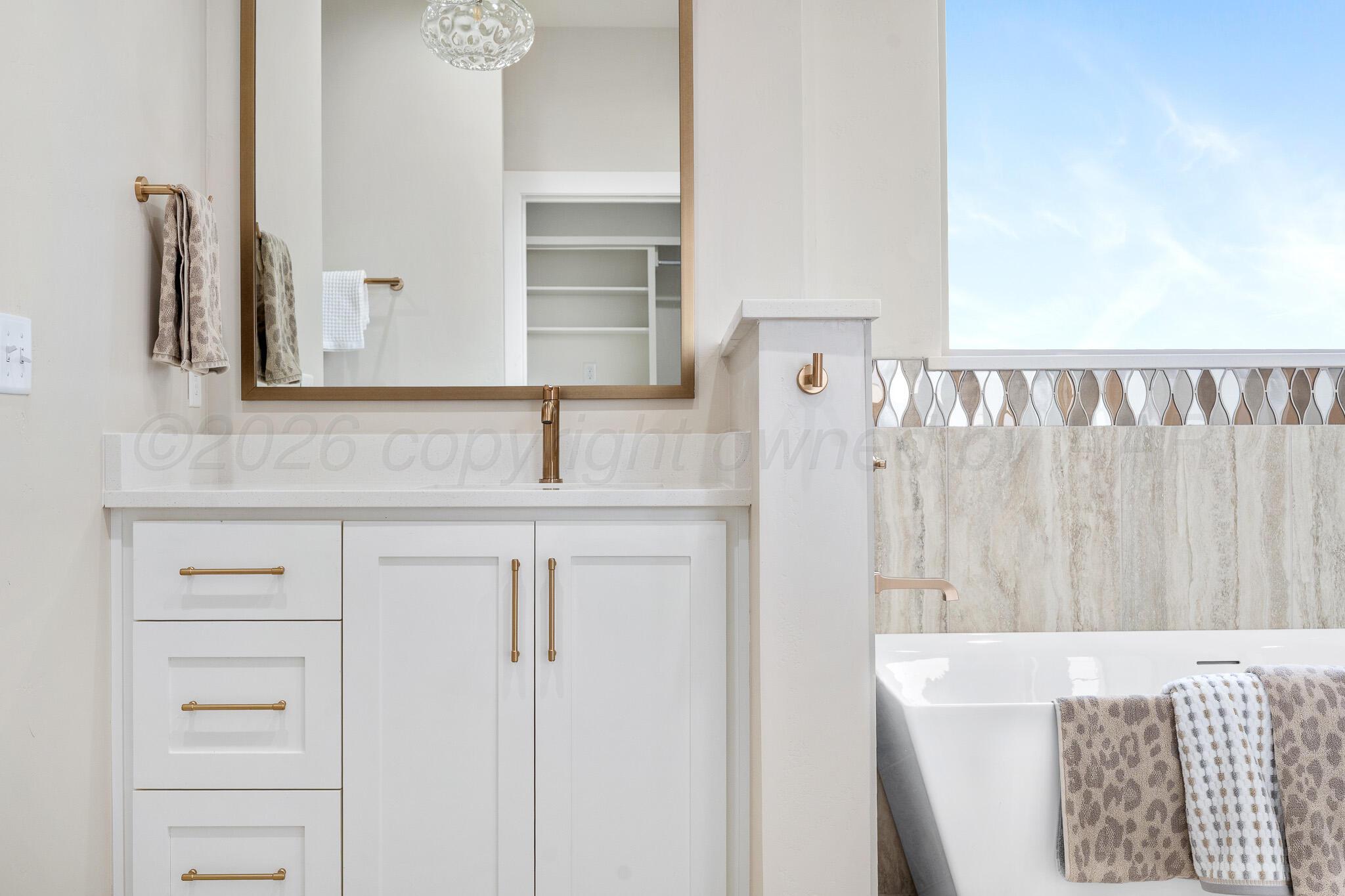 4000 Juniper Springs Road Amarillo, TX 79119 - Photo 26 of 40 a bathroom with a sink vanity and a mirror