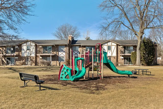 a view of a bedroom with a table and chairs