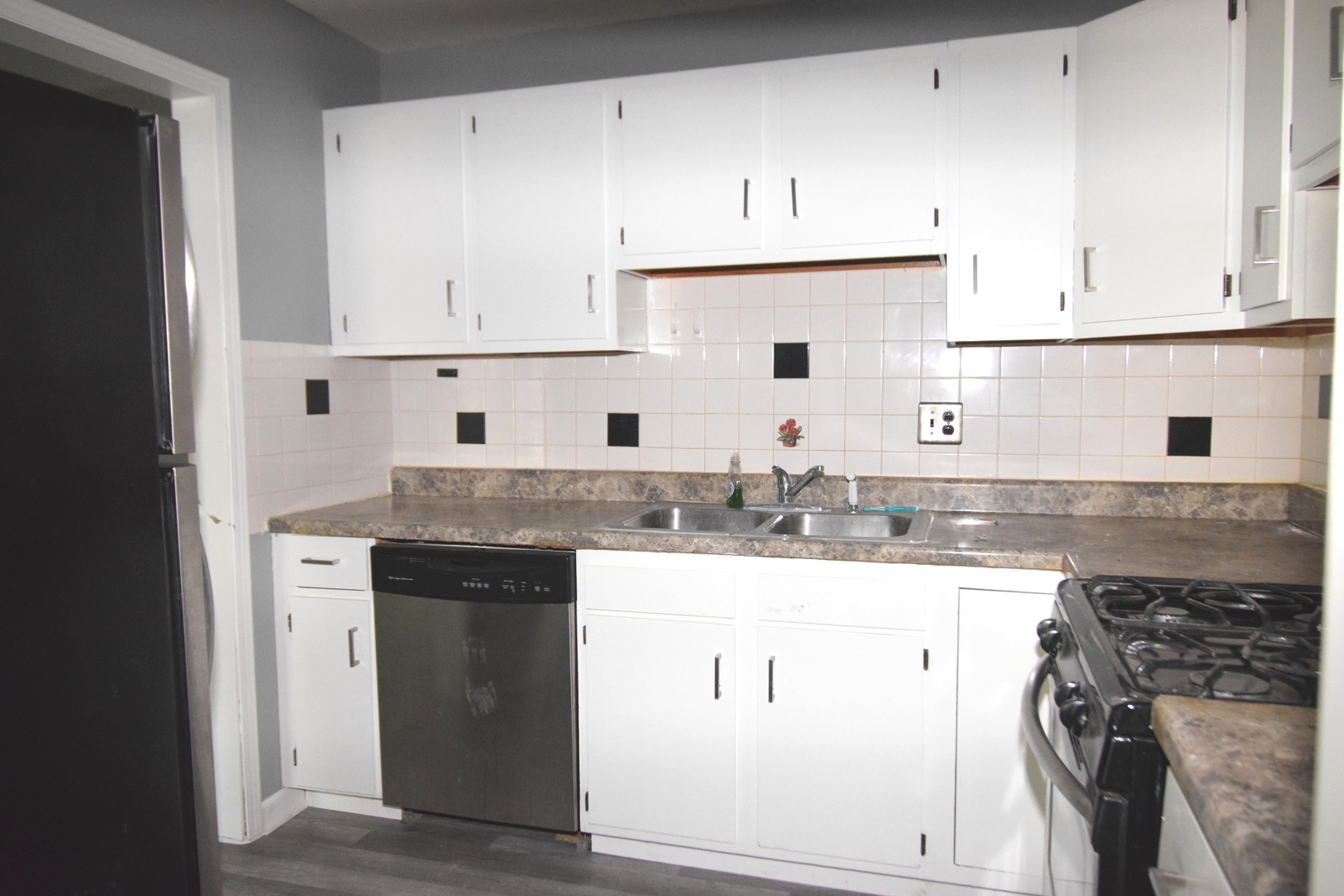 9-s120 Lake Drive, Unit 201 Willowbrook, IL 60527 - Photo 6 of 17 a kitchen with granite countertop a sink a stove and cabinets