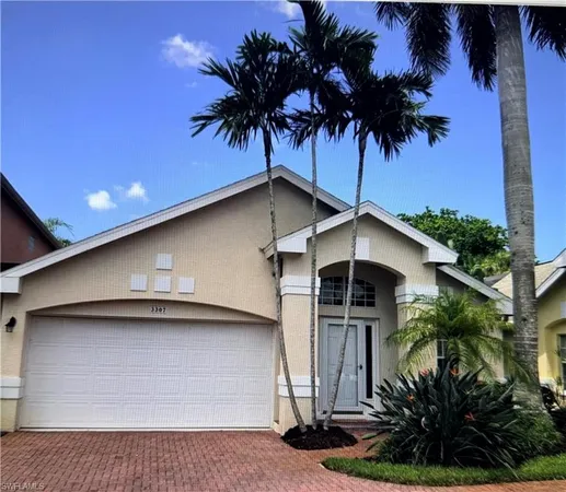 a house with a palm plant and a yard