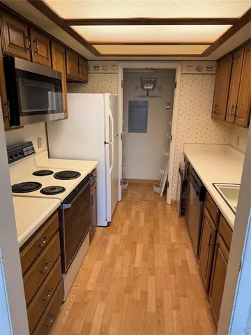 a kitchen with a sink stove and refrigerator