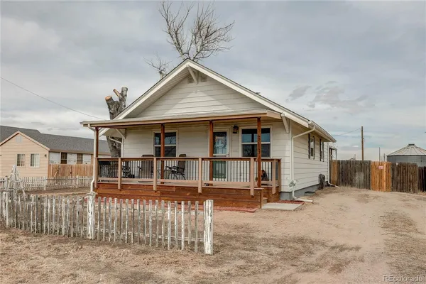 a view of a house with wooden fence