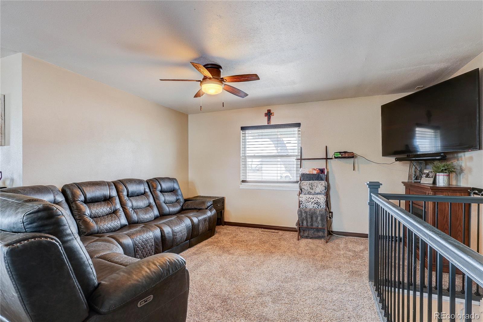 313 Front Street Roggen, CO 80652 - Photo 11 of 49 a living room with furniture and a flat screen tv