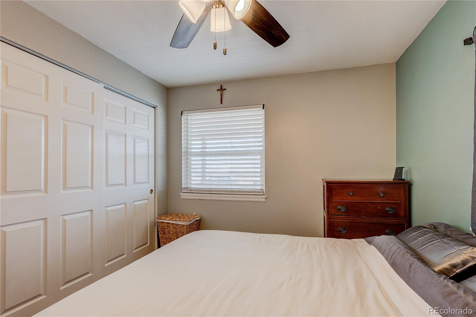 313 Front Street Roggen, CO 80652 - Photo 14 of 49 a bedroom with a bed and a dresser