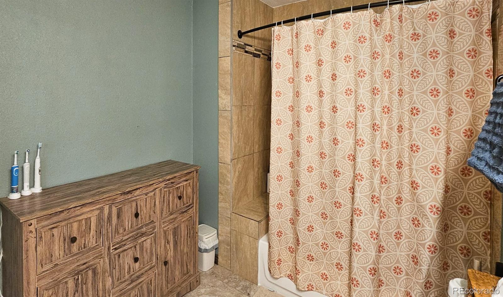 313 Front Street Roggen, CO 80652 - Photo 17 of 49 a bathroom with a shower curtain and sink