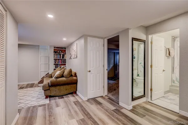 a living room with furniture and a wooden floor