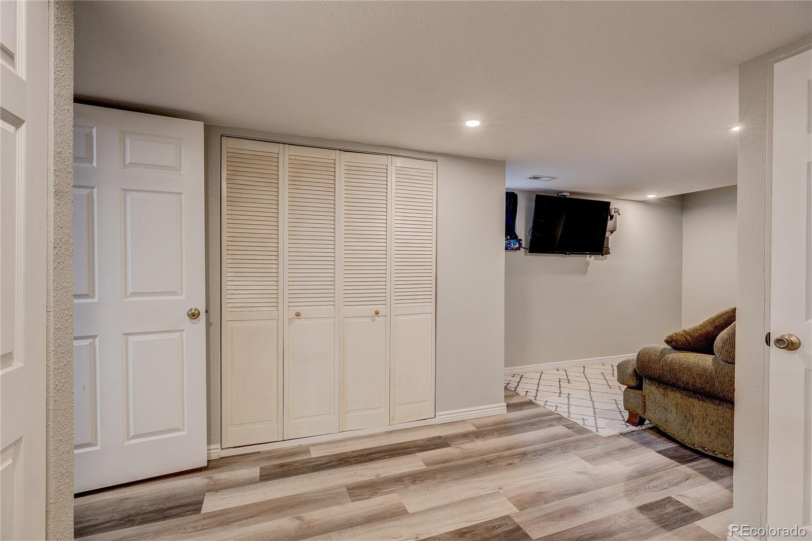 313 Front Street Roggen, CO 80652 - Photo 20 of 49 a living room with furniture and a flat screen tv