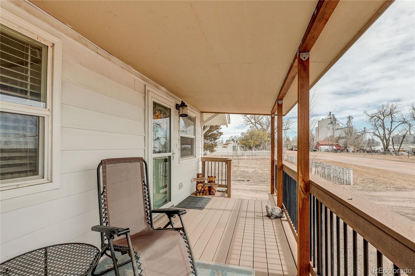 313 Front Street Roggen, CO 80652 - Photo 2 of 49 a view of a balcony with furniture and wooden floor