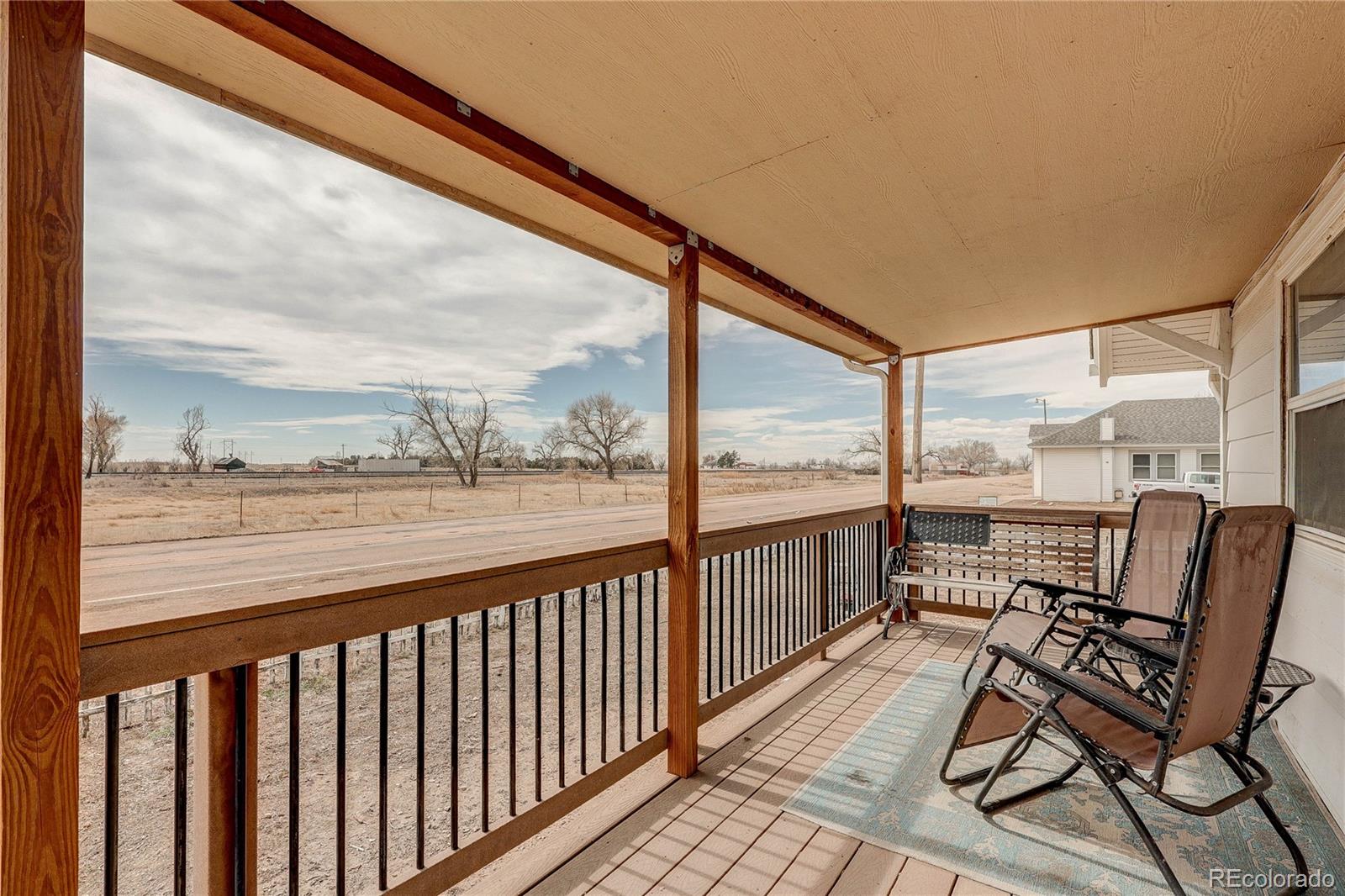 313 Front Street Roggen, CO 80652 - Photo 3 of 49 a view of a city from a balcony with furniture