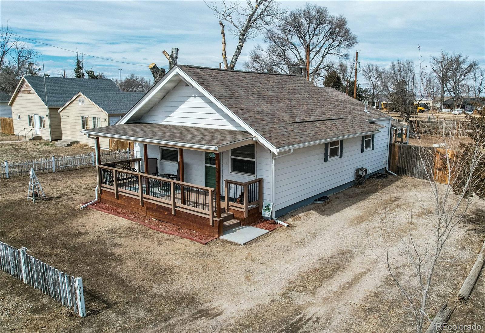 313 Front Street Roggen, CO 80652 - Photo 40 of 49 a view of a house with a yard and wooden fence