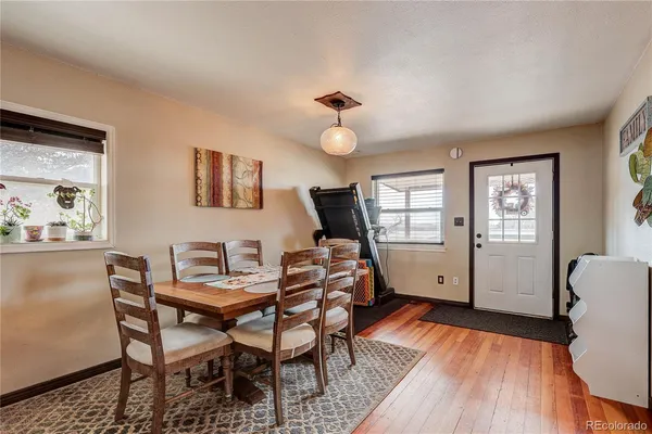 a workspace room with furniture and wooden floor