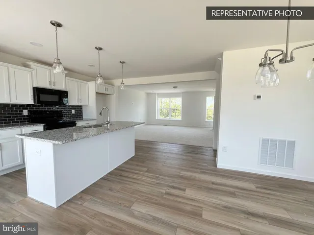 a view of a living room a refrigerator and an oven