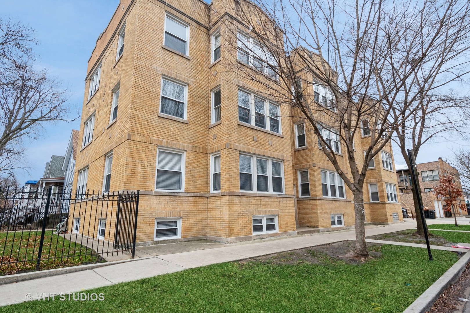 3337 West Byron Street, Unit 1 Chicago, IL 60618 - Photo 1 of 12 front view of a building with a yard