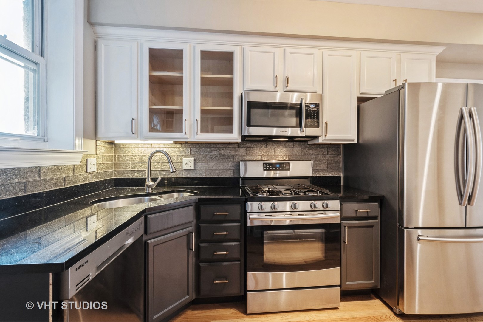 3337 West Byron Street, Unit 1 Chicago, IL 60618 - Photo 5 of 12 a kitchen with stainless steel appliances granite countertop a stove a refrigerator and a sink