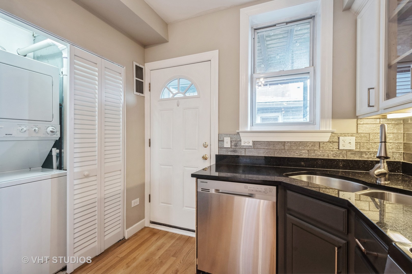 3337 West Byron Street, Unit 1 Chicago, IL 60618 - Photo 7 of 12 a kitchen with granite countertop a sink and a stove