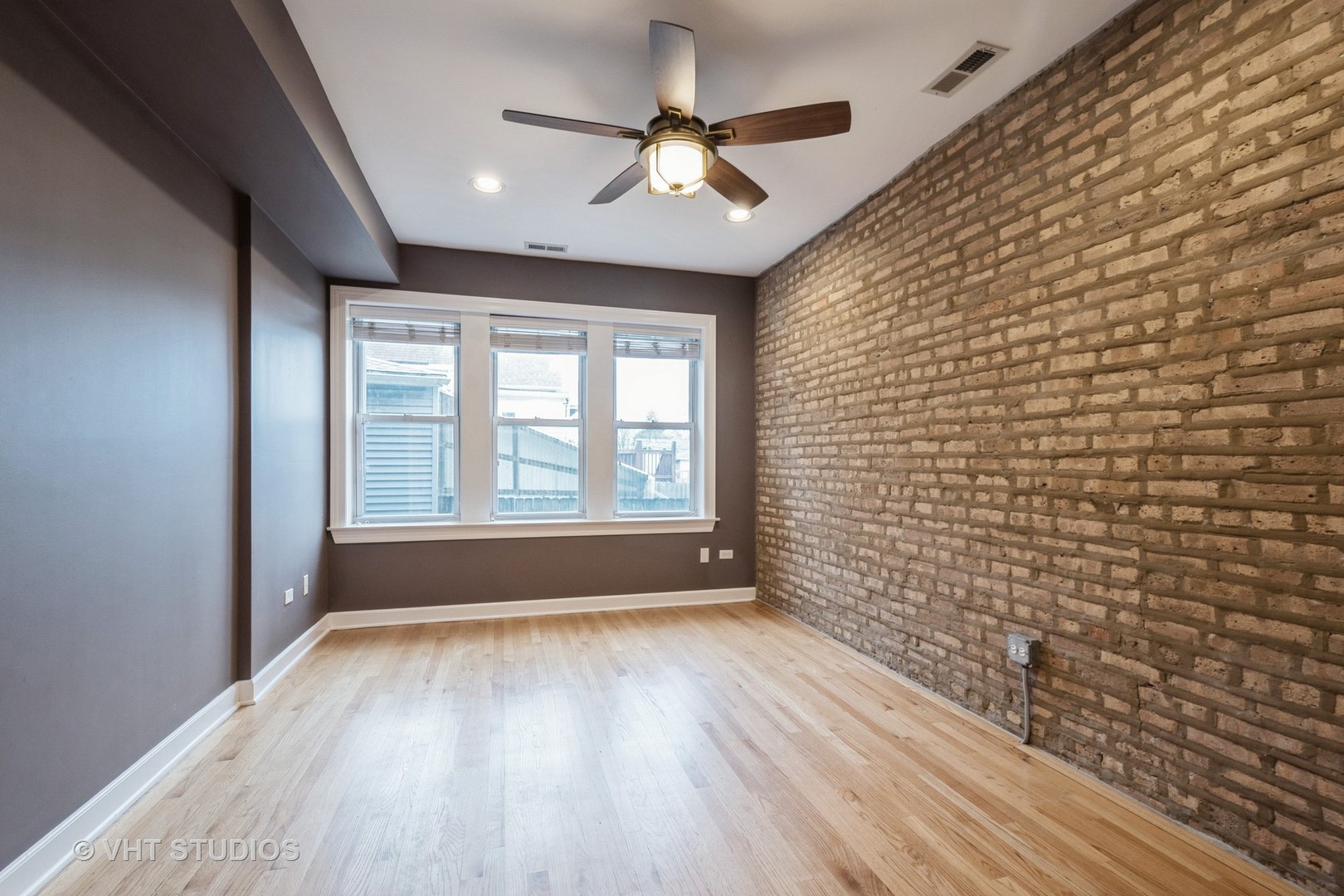 3337 West Byron Street, Unit 1 Chicago, IL 60618 - Photo 10 of 12 a view of an empty room with a window and wooden floor