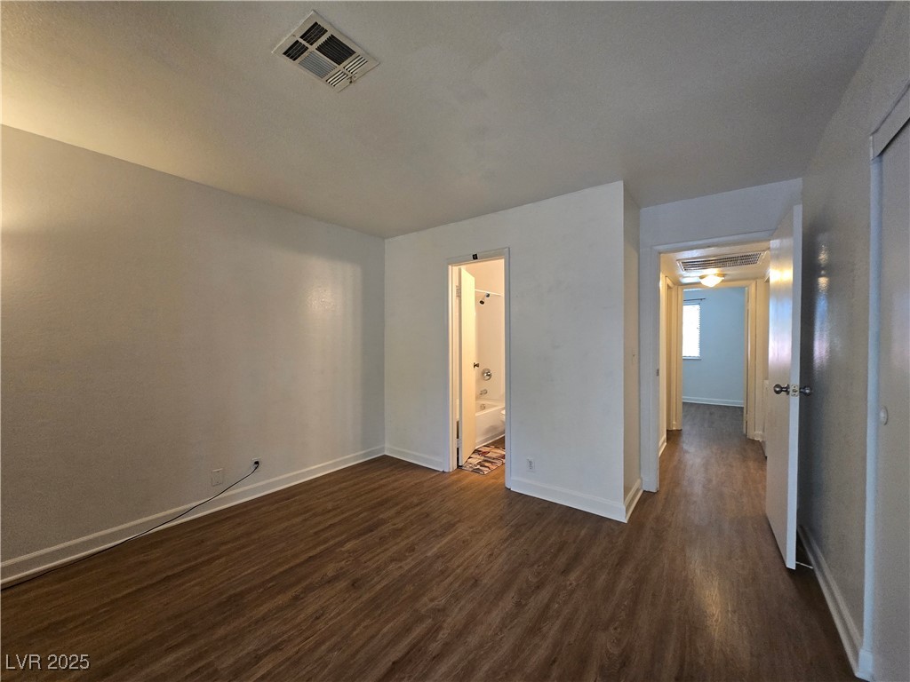 4440 Rich Drive, Unit C Las Vegas, NV 89102 - Photo 11 of 15 Unfurnished bedroom with dark wood-style floors and baseboards
