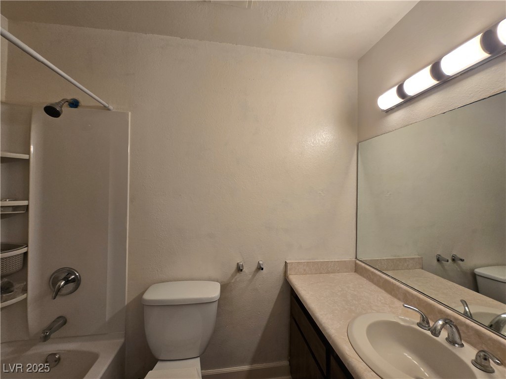 4440 Rich Drive, Unit C Las Vegas, NV 89102 - Photo 13 of 15 Full bathroom featuring bathtub / shower combination, vanity, and a textured wall