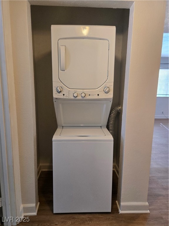 4440 Rich Drive, Unit C Las Vegas, NV 89102 - Photo 15 of 15 Laundry area featuring dark wood-type flooring, a textured wall, and stacked washer / drying machine