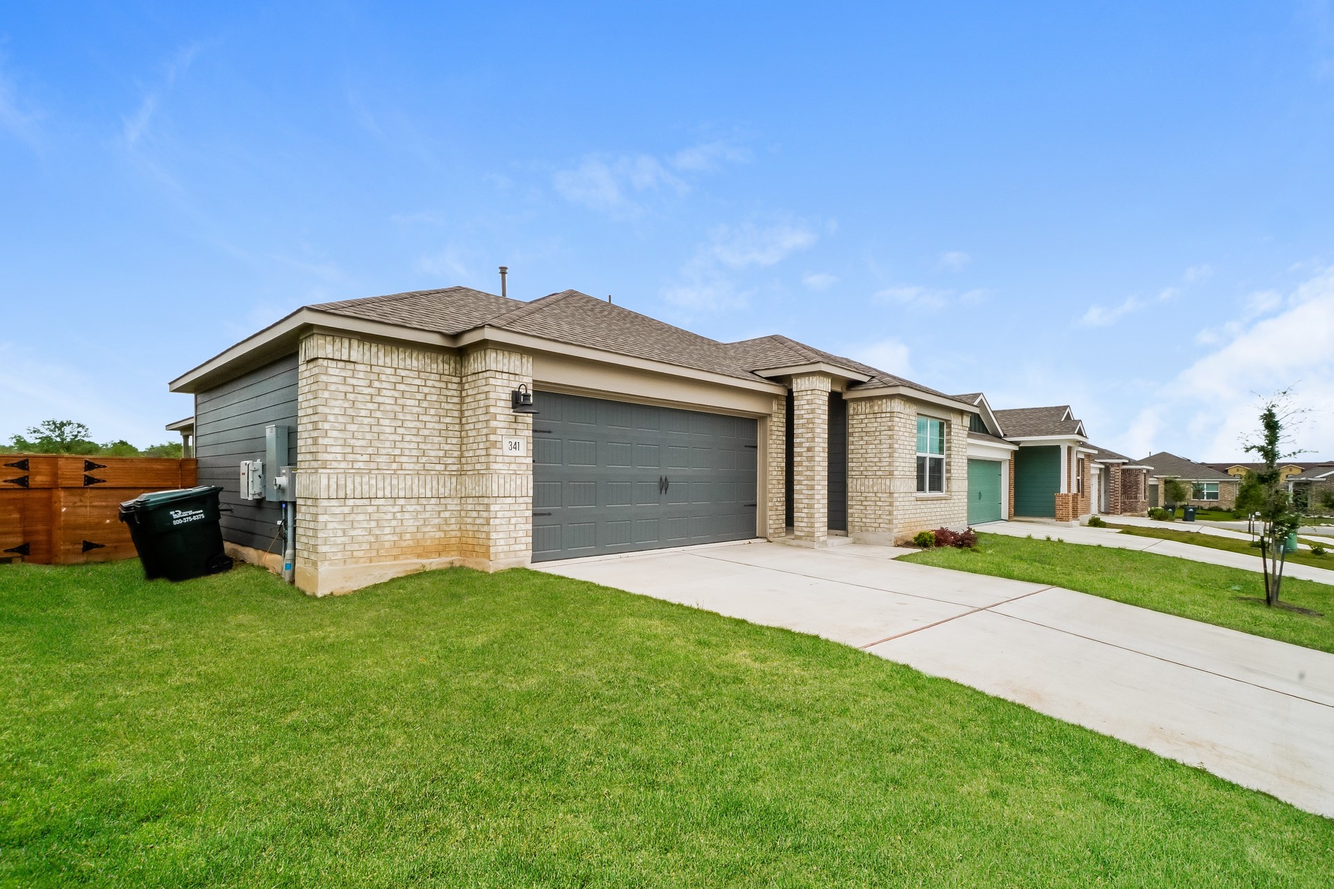 341 Madrid Kyle, TX 78640 - Photo 2 of 27 A well-maintained lawn and sturdy brick exterior define this charming single-story residence.