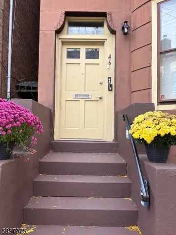 a vase of flowers sitting on a floor