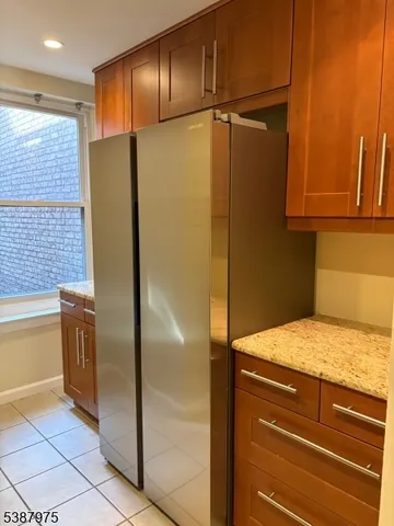 a kitchen with a refrigerator and cabinets