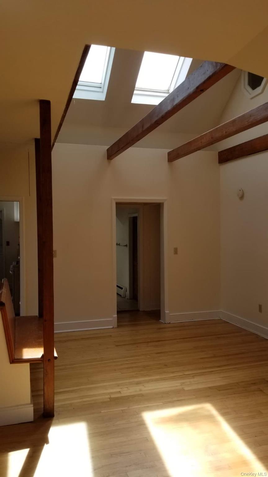 92 Roe Avenue, Unit 3 Highland Falls, NY 10928 - Photo 10 of 17 Vaulted ceiling featuring skylights and exposed wood beams