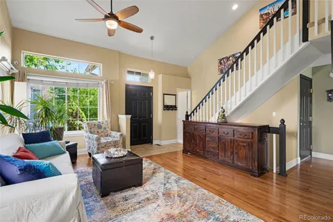 a living room with furniture or wooden floor and a large window