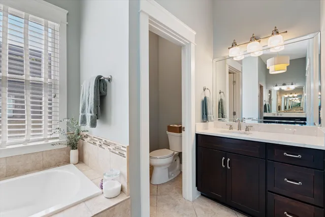 a bedroom with a bed and a lamp on dresser