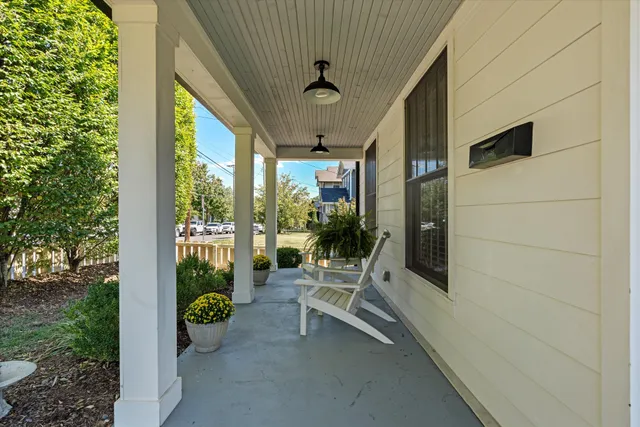 a kitchen with stainless steel appliances granite countertop a stove a refrigerator a sink a white with a dining table and chairs