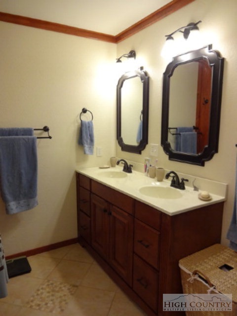 158 Jesse Brown Road Boone, NC 28607 - Photo 3 of 18 a bathroom with a double vanity sink and a mirror