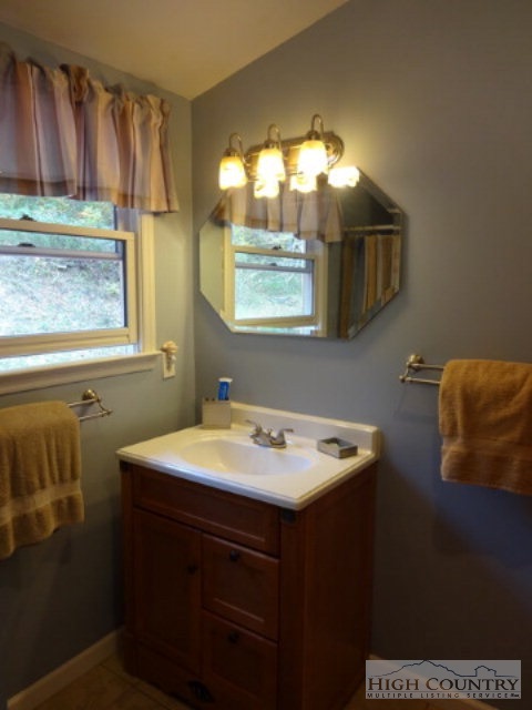 158 Jesse Brown Road Boone, NC 28607 - Photo 7 of 18 a bathroom with a sink a vanity and a mirror
