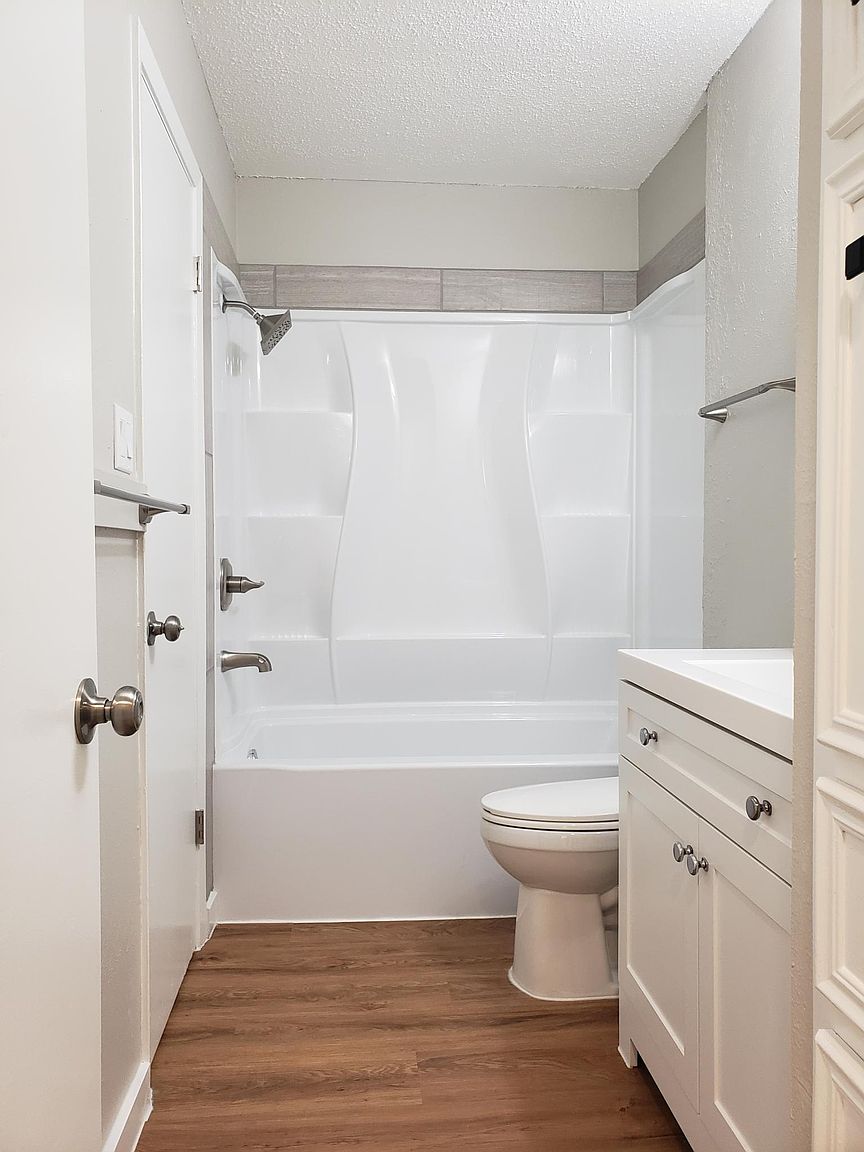 802 Ranch Road, Unit A Georgetown, TX 78628 - Photo 6 of 11 A well-appointed bath features a bright white tub and a coordinated vanity with ample storage.
