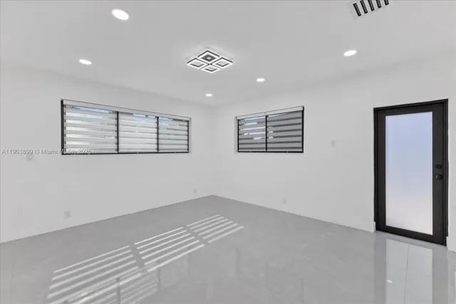 a view of a room with a white wall and a window