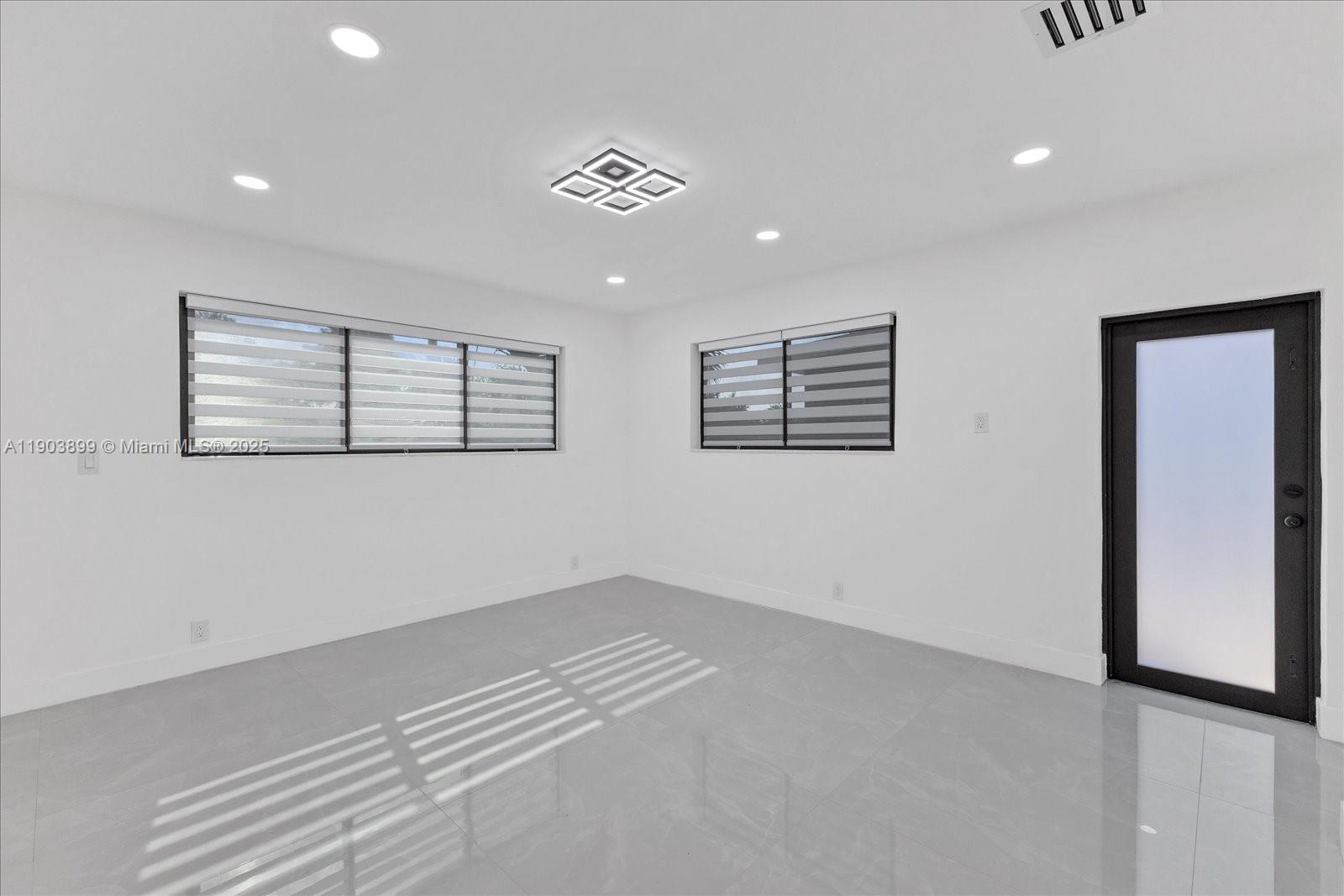 19511 Northeast 18th Place Miami, FL 33179 - Photo 20 of 38 a view of empty room with windows