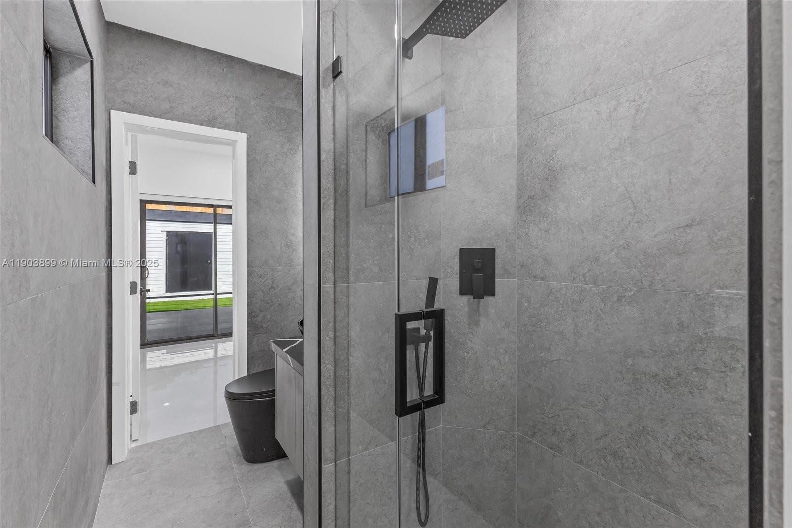 19511 Northeast 18th Place Miami, FL 33179 - Photo 22 of 38 a bathroom with a shower