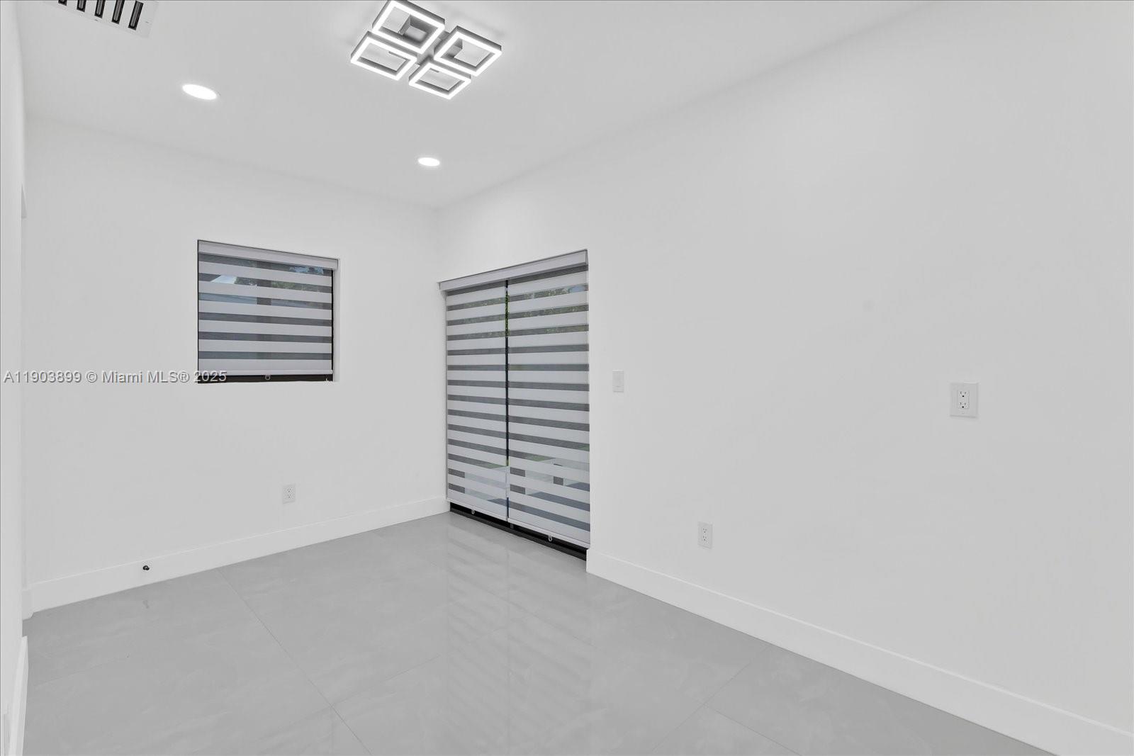 19511 Northeast 18th Place Miami, FL 33179 - Photo 25 of 38 a view of a room with a white wall and a window