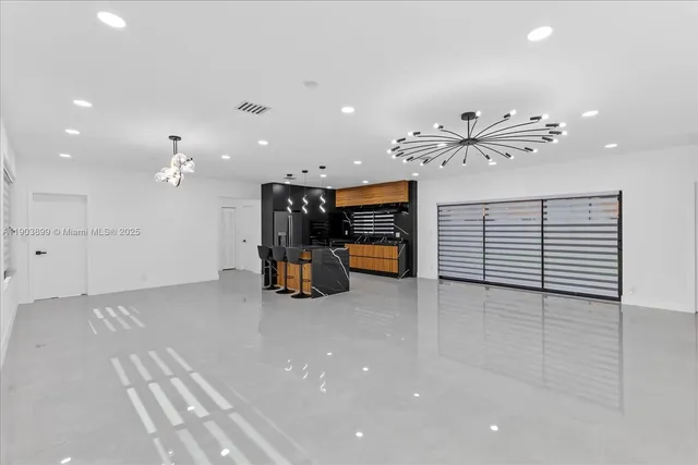 an empty room with windows and ceiling fan