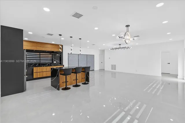 an empty room with windows and ceiling fan