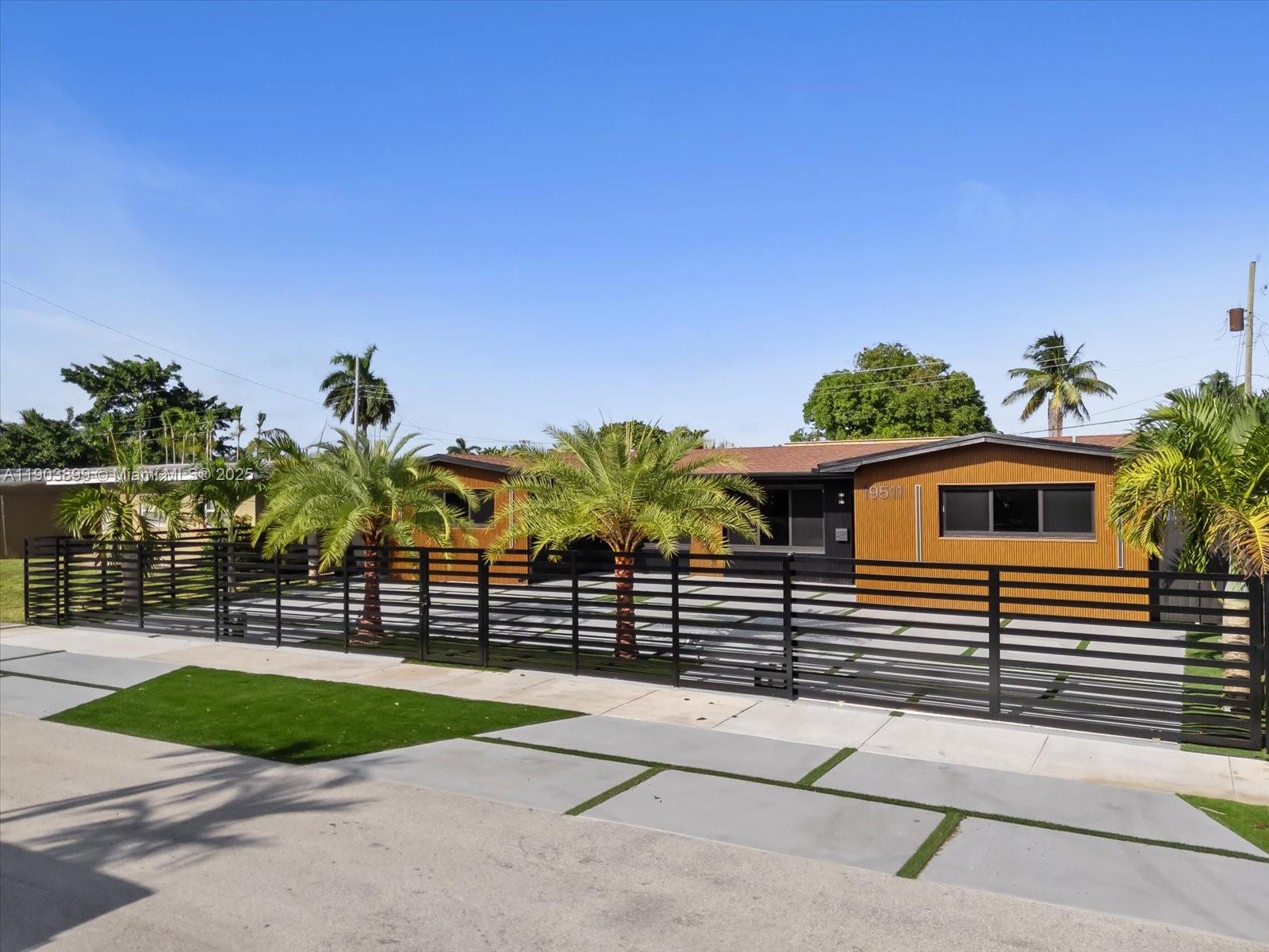 19511 Northeast 18th Place Miami, FL 33179 - Photo 3 of 38 a view of a house with a backyard