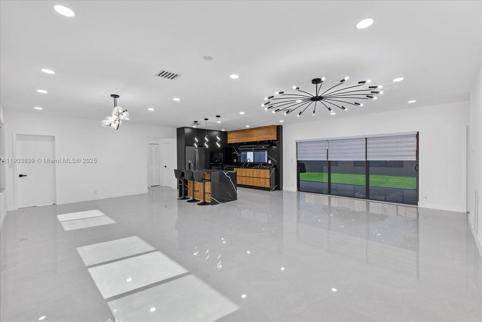 19511 Northeast 18th Place Miami, FL 33179 - Photo 32 of 38 an empty room with windows and ceiling fan