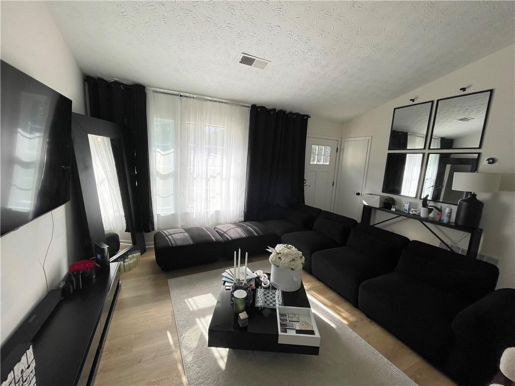 3915 Basil Way Southwest Atlanta, GA 30331 - Photo 3 of 21 a living room with furniture and a flat screen tv