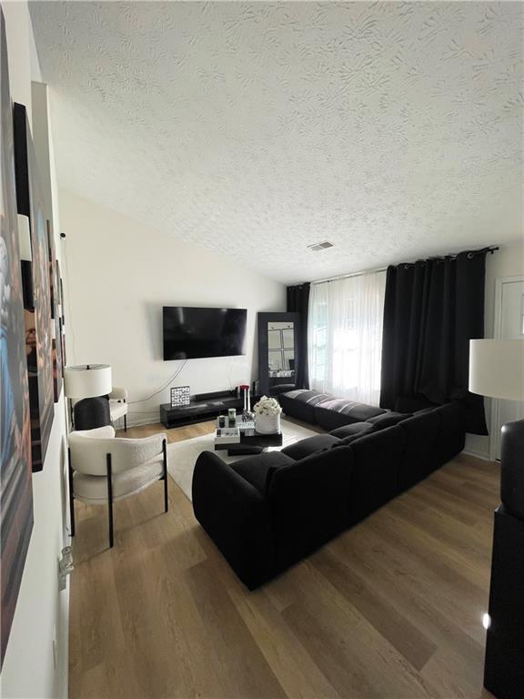 3915 Basil Way Southwest Atlanta, GA 30331 - Photo 5 of 21 a living room with furniture a flat screen tv and a fireplace