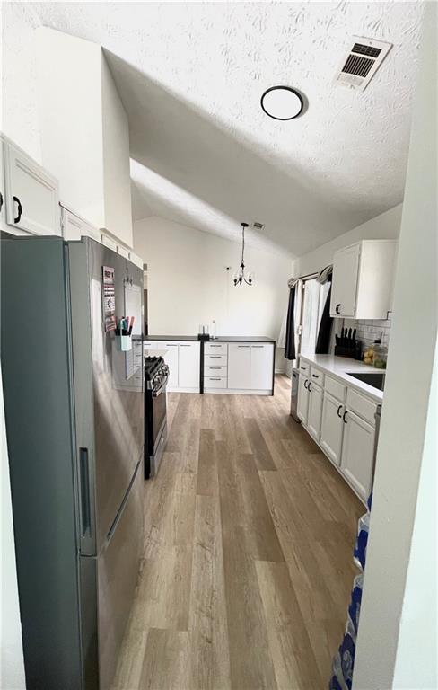 3915 Basil Way Southwest Atlanta, GA 30331 - Photo 8 of 21 a view of a kitchen with refrigerator stove and wooden floor