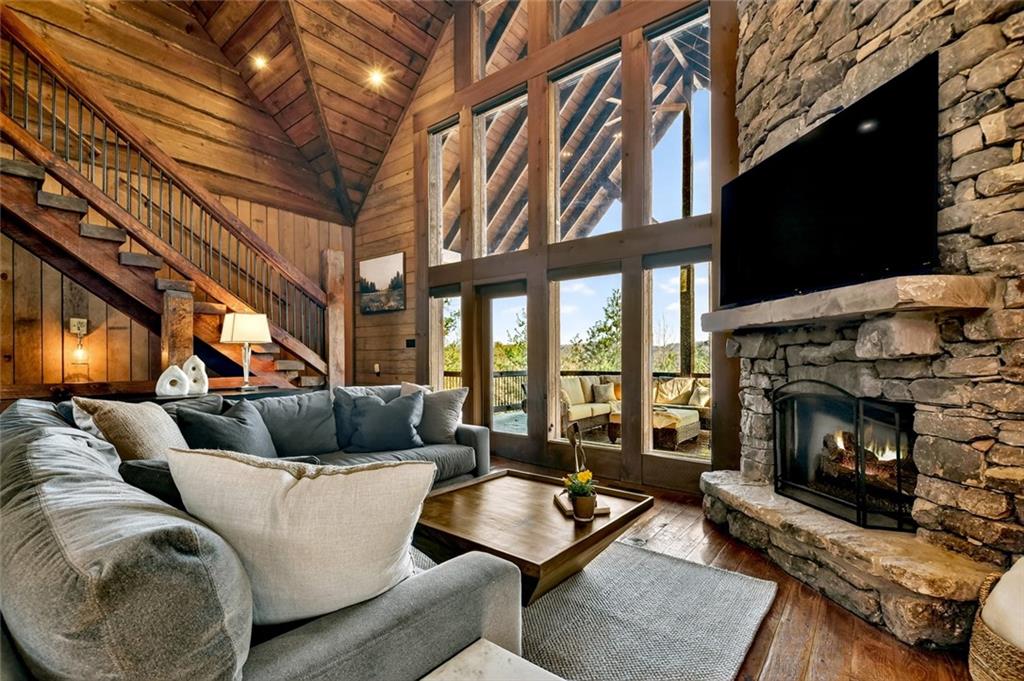 249 Settlement Road Epworth, GA 30541 - Photo 17 of 74 a living room with furniture a flat screen tv and a fireplace